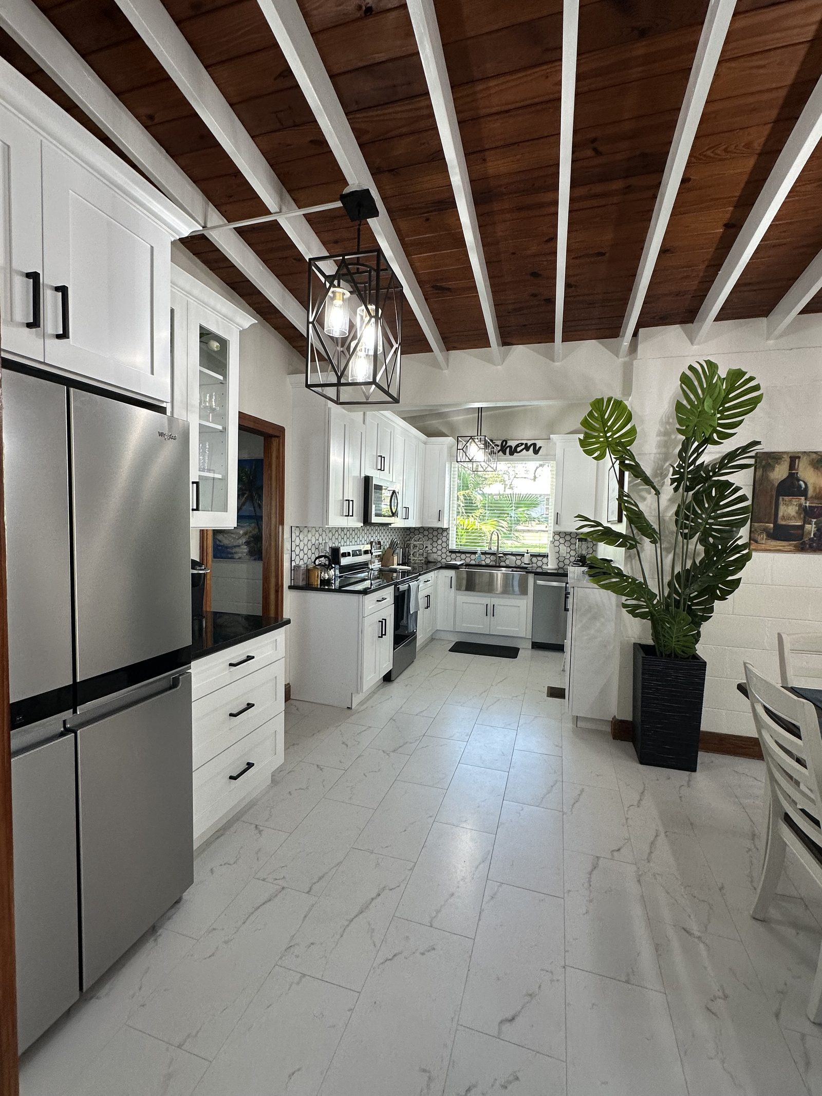 The kitchen with farmhouse sink and stainless appliances