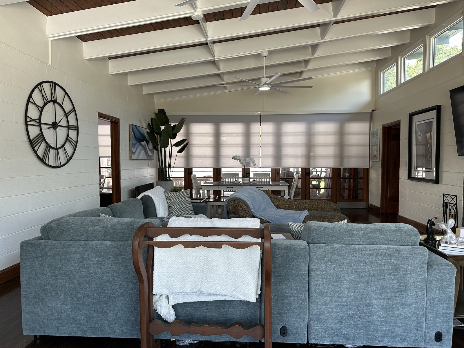 Open living and dining under the beamed ceiling