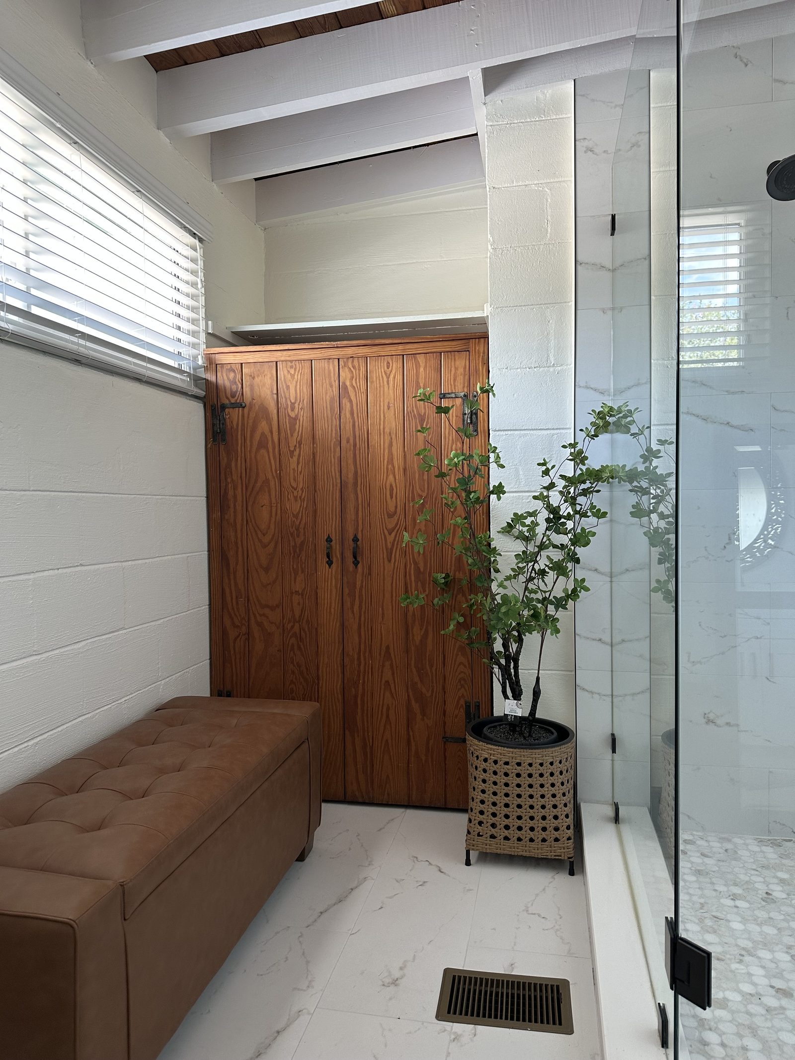 The main suite dressing area and glass shower